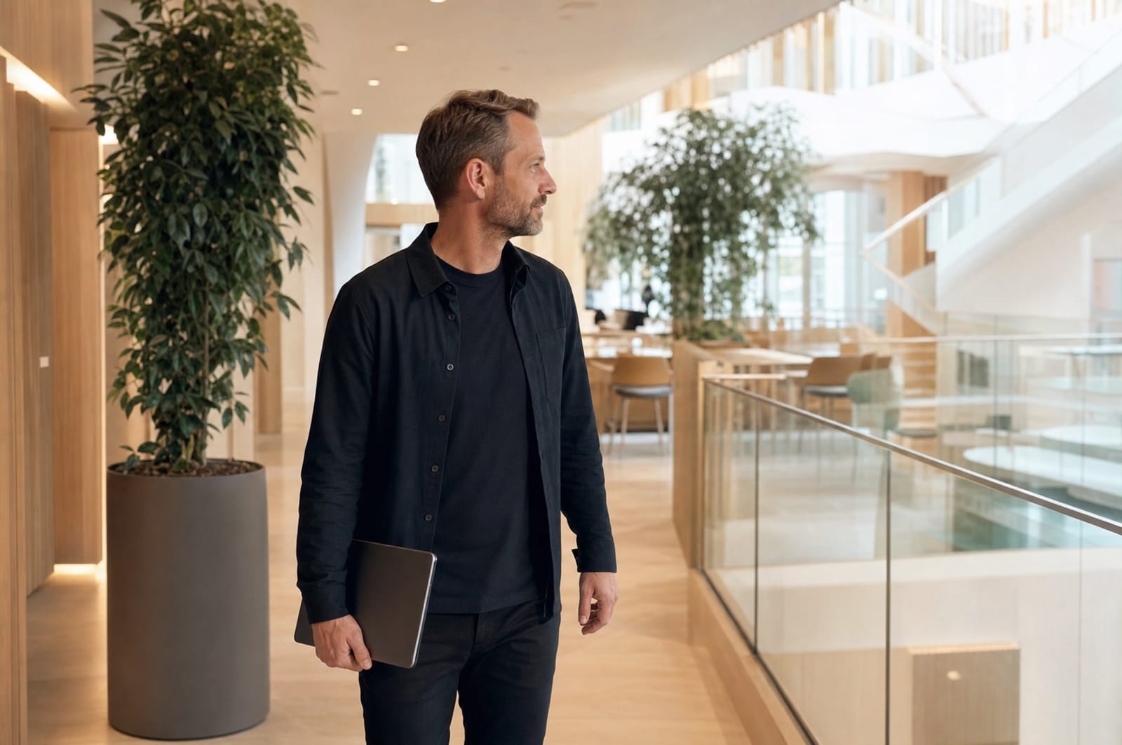 Facility manager walking through the atrium of a modern office building